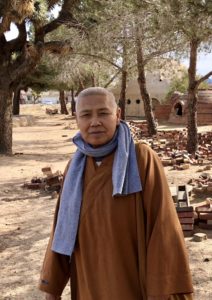 Zhizang Shi (Sonya) inspecting the superadobe structures at Cal-Earth.