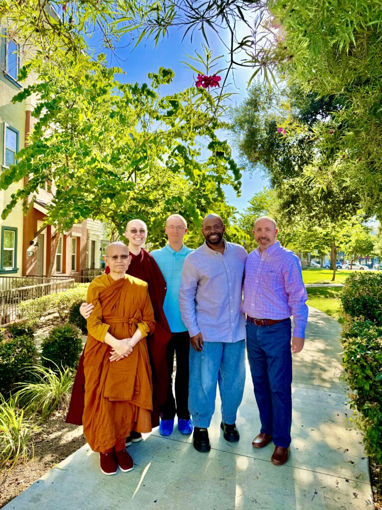 some sangha members enjoying the amrita fall outside of H.H. Dorje Chang Buddha III Cultural and Art Museum June 2024.