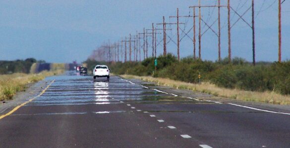 Photo of a mirage of water on a road.